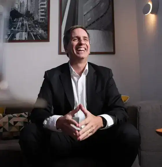 man smiling in white shirt and black suit