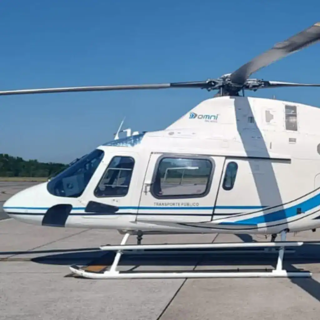 white helicopter with blue stripes on the ground