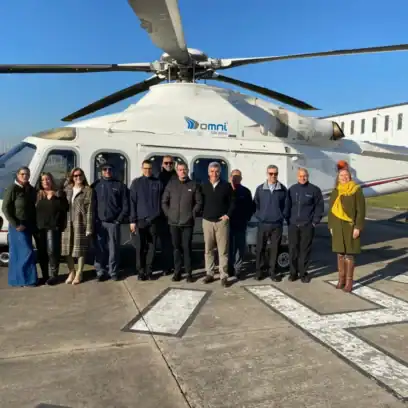 group of people in front of helicopter