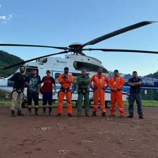 group of people in front of helicopter