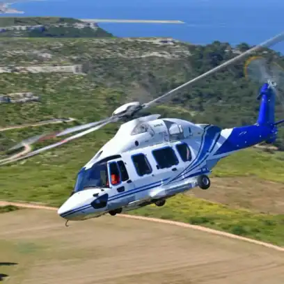 white and blue helicopter flying