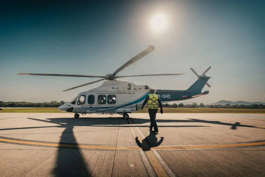 helicopter on the ground with sun in the sky