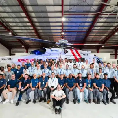 group of people in front of an helicopter