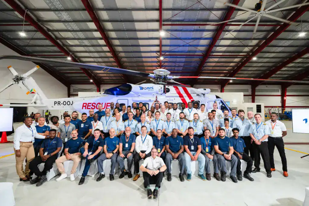 group of people in front of an helicopter