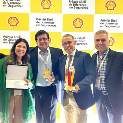 one woman and three men smiling