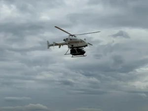 helicopter flying in grey cloudy sky